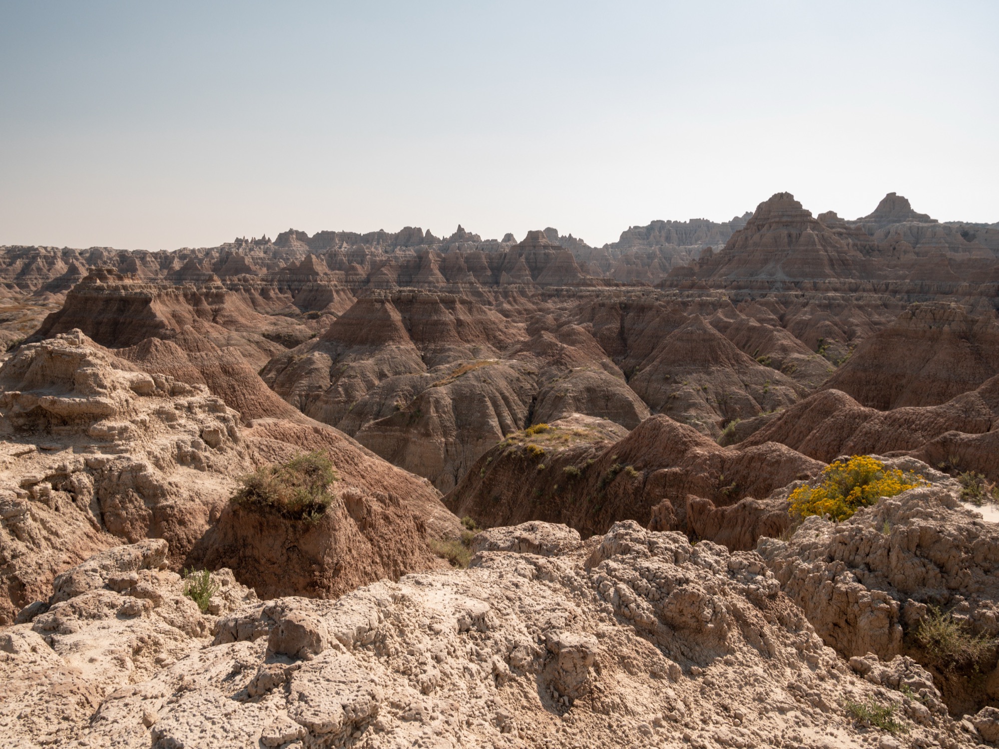Steep eroded canyons of banded sedimentary rock in Badlands National Park.