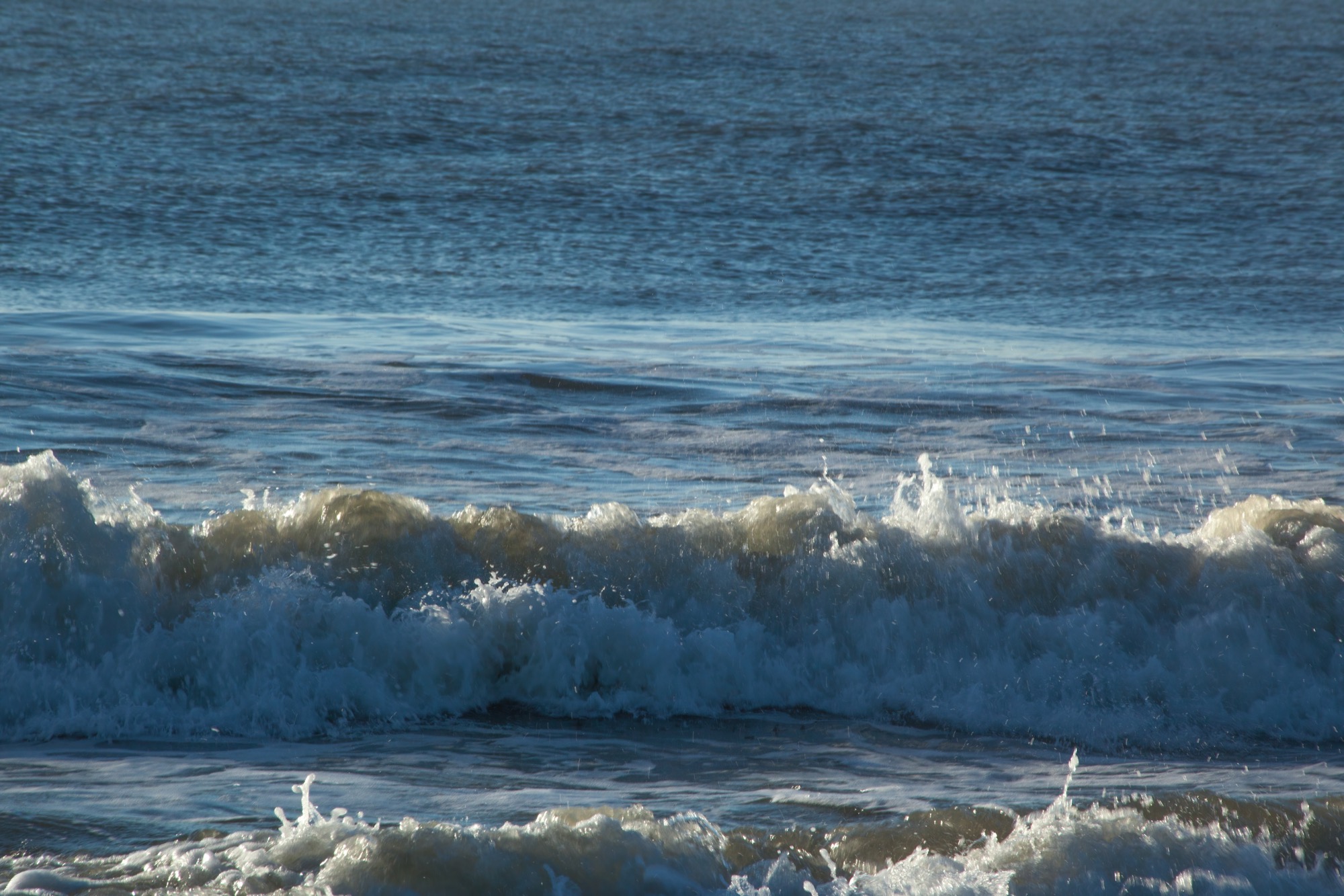 The open sea under a wide sky, waves stretching to the horizon.